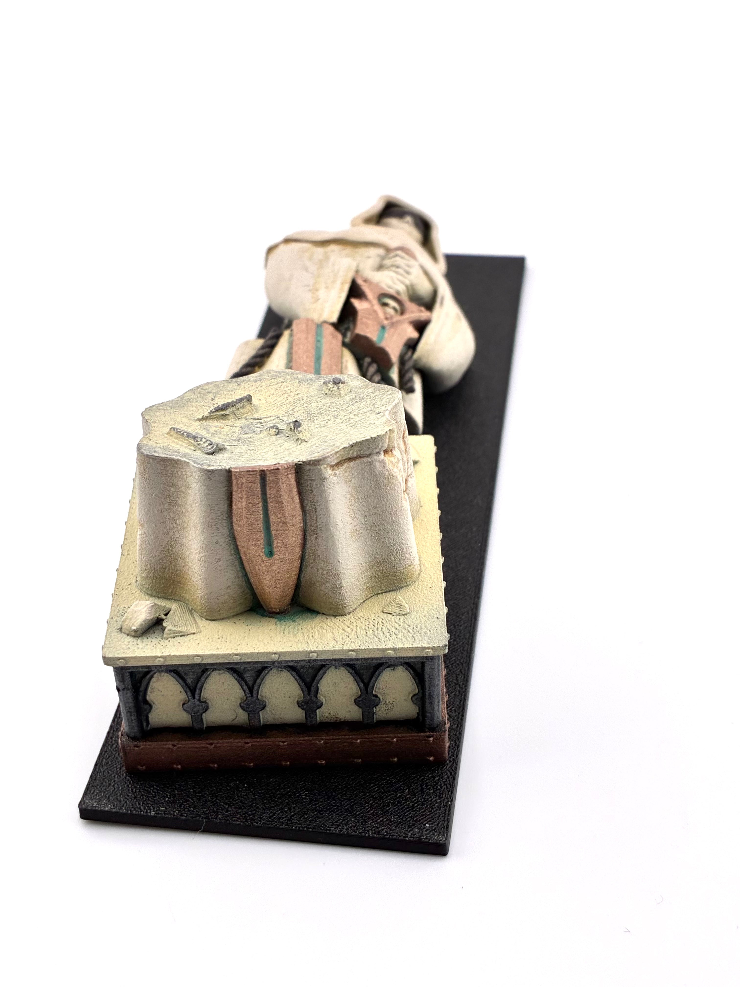 Lateral view of the fallen statue on a black 6"x2" footprint